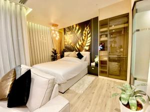 a bedroom with a white bed and a couch at arom wongamat in Pattaya North +11 photos