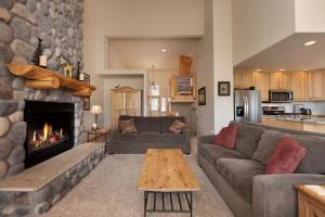 a living room with a couch and a fireplace at Private Garage, Washer and Dryer, Amazing Views of Byers Peak, Pet Friendly in Fraser
