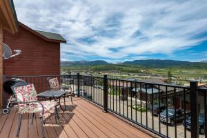 a balcony with two chairs and a table and a view at Private Garage, Washer and Dryer, Amazing Views of Byers Peak, Pet Friendly in Fraser +36 photos