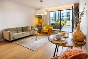 a living room with a couch and a table at Terra Luxe Residence in Bucharest