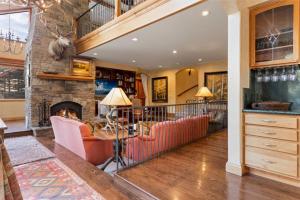 a living room with a couch and a fireplace at Outdoor Private Hot Tub, In Home Movie Theater, Luxurious Creekside Home in Vail