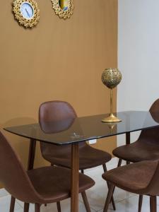 a glass table with chairs and a vase on a wall at Casa Palma Tranquility 2 bedrooms in Salento