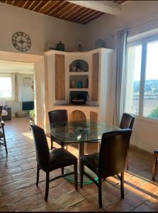 a dining room with a glass table and chairs at Maison de vacances en pleine nature in Aurons +17 photos