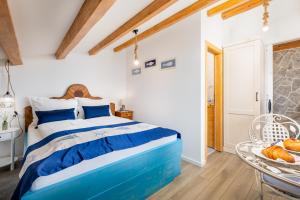 a bedroom with a blue and white bed and a table at Vila Mare in Risika +74 photos