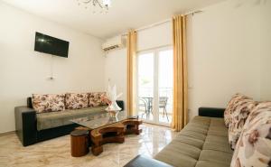 a living room with a couch and a glass table at Villa Champion in Ulcinj
