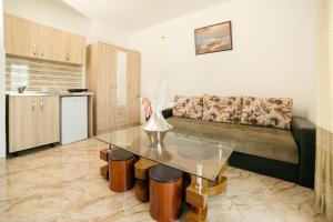 a living room with a couch and a table at Villa Champion in Ulcinj