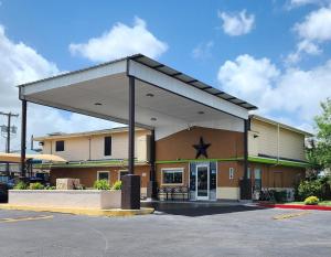 a gas station with awning in a parking lot at Rodeway Inn San Antonio Lackland AFB - SeaWorld in San Antonio