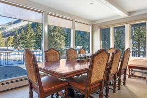 a dining room with a table and chairs and windows at Private Hot Tub and Sauna, Right on Fairway, Minutes From Vail Village & Golden Peak in Vail