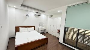 a small bedroom with a bed and a window at Era Apartment La Thành in Hanoi