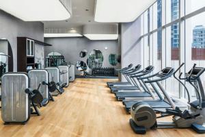 a gym with rows of treadmills and ellipticals at The St. Regis Chengdu in Chengdu