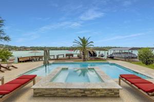 a swimming pool with red cushioned chairs at La Costa Drive in Montgomery