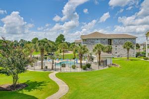 a yard with a pool and a house at 2 Mi to Beach Pool-View Myrtle Beach Escape! in Myrtle Beach