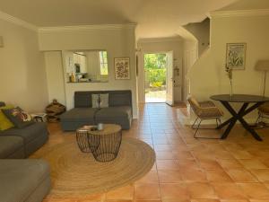 a living room with a couch and a table at Maison du Lac in Grimaud