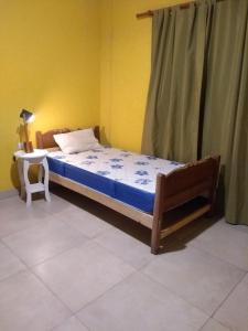 a bedroom with a bed and a chair in a room at Casa en Amaicha in Amaicha del Valle +1 photo