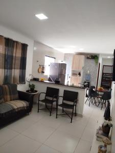 a living room with a couch and chairs and a kitchen at Casa de veraneio - FA Beach in Conde +14 photos