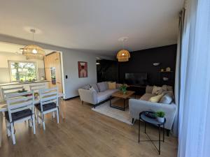 a living room with a couch and a table and chairs at Chill House in Zator