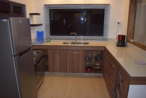 a kitchen with a stainless steel refrigerator and a sink at Mountain View Studio in La Gaulette