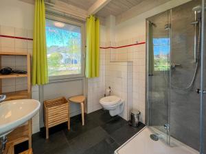 a bathroom with a toilet and a shower and a sink at Familienunterkunft Wiesengeflüster E8 - strandnah mit Sauna und Garten in Röbel
