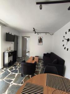 a living room with a couch and a table at MAGIA's HOUSE in Karistos