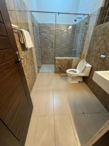 a bathroom with a toilet and a shower and a sink at Mountain Villa Family Guest House in Islamabad +62 photos