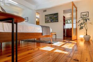 a bedroom with a bed and a wooden floor at TreeTops Spacious Architectural Retreat in Gainesville