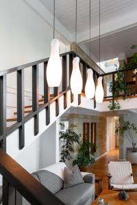 a living room with a staircase with pendant lights at TreeTops Spacious Architectural Retreat in Gainesville