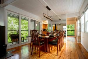 a dining room with a table and some chairs at TreeTops Spacious Architectural Retreat in Gainesville +95 photos