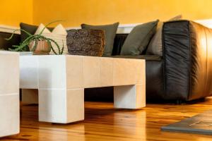 a coffee table in front of a couch at TreeTops Spacious Architectural Retreat in Gainesville