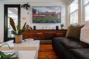 a living room with a couch and a table at TreeTops Spacious Architectural Retreat in Gainesville +95 photos