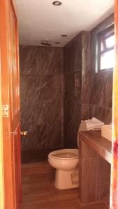 a bathroom with a toilet and a sink at HOTEl CHAIS in Colorines