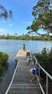 a person on a bike on a dock on a lake at Waterview Cottage in Baffle Creek