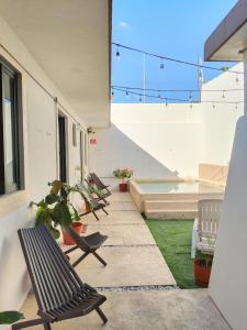 a row of chairs sitting on a patio at Kambal Peregrino in Mérida +2 photos