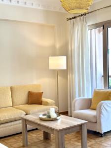 a living room with two couches and a coffee table at CityCenter Apartment in Argostoli