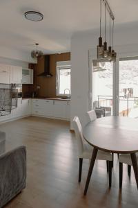 a kitchen and dining room with a table and chairs at Big Family apartment - 3BR in Budva