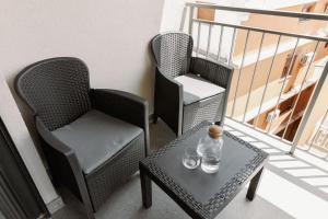 two chairs and a table on a balcony at Big Family apartment - 3BR in Budva +19 photos
