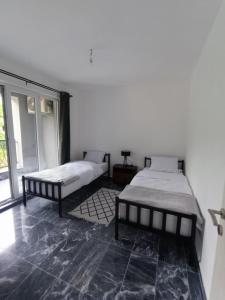 Ένα ή περισσότερα κρεβάτια σε δωμάτιο στο TriM Apartments