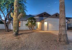a house with a cactus in front of a garage at Soak In Private Heated Pool In Stylish Open Plan H in Phoenix