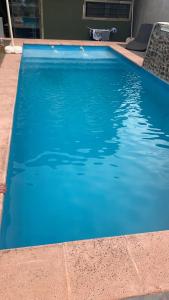 a swimming pool with blue water in a house at Alojamiento Napoleon in Puerto Iguazú +5 photos