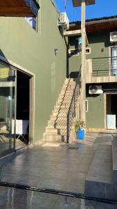 a building with a staircase and a building with a door at Alojamiento Napoleon in Puerto Iguazú