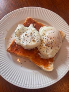 a white plate with two poached eggs on top of toast at Stone Lodge Bed & Breakfast in Navan