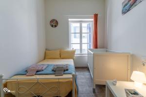 a small bedroom with a bed and a window at 'Omiros' Central Cozy House In Poro Island in Poros