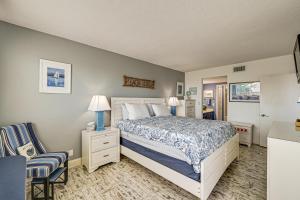 a bedroom with a bed and a chair at Pool Access Relaxing Naples Bay Extended Stay! in Naples +16 photos