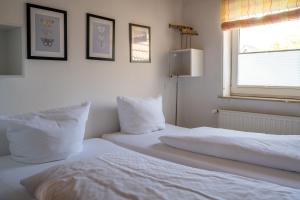 Ένα ή περισσότερα κρεβάτια σε δωμάτιο στο Haus Pusteblume Wohnung 2