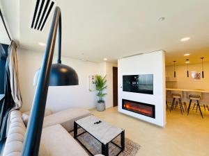 a living room with a couch and a fireplace at 2BHK with Hill and Lake view in Mall of Islamabad Blue Area in Islamabad