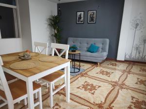 a living room with a table and a couch at Hostal Ángel Victoria in Yopal +15 photos