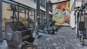 a gym with a bunch of exercise bikes at Cosmic Serenity Retreat 1BD Lux King in Southeast Jax in Jacksonville