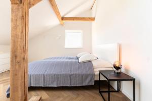 una camera da letto con un letto e un tavolo di 2 BR Loft - LUXUS - MODERN - PARKPLÄTZE - KAFFEE - NETFLIX - WEINBERGBLICK - KÜCHE - BALKON a Rüdesheim am Rhein
