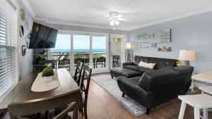 a living room with a couch and a table at Sea Haunts 1A in Santa Rosa Beach