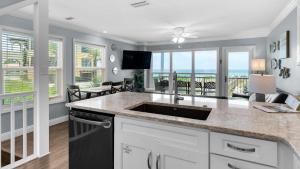 a kitchen with a sink and a view of the ocean at Sea Haunts 1A in Santa Rosa Beach