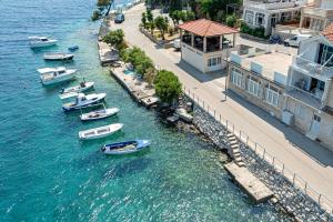 a group of boats in a body of water at Apartments by the sea Brna, Korcula - 17583 in Smokvica